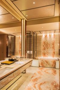 a bathroom with two sinks and a large mirror at MGM Cotai in Macau