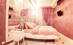 a pink bedroom with a bed and a mirror at Welcome to Poltava Apartments in Poltava