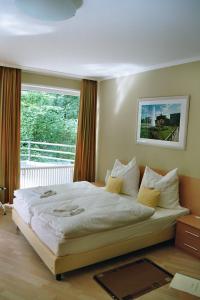 a bedroom with a large bed in front of a window at Tillmanns-Haus in Berlin