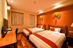 Tempat tidur dalam kamar di T&T Story Hotel (Xi Gong Pier)