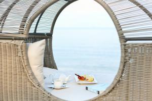 a dining room table with a view of the ocean at U Pattaya - SHA Certified in Na Jomtien