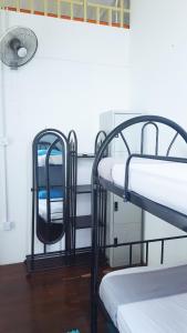 two bunk beds in a room with a fan at GH Great Homes in Kuching