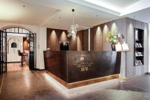 a lobby with a reception desk in a building at Hotel Luna Mondschein in Ortisei