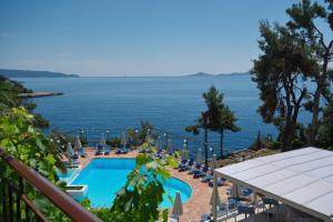 a view of a swimming pool and the ocean at Paradise Hotel in Patitiri