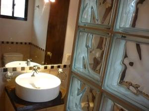 a bathroom with a sink and a mirror at Aloha Village in La Pedrera
