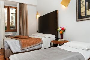 Llit o llits en una habitació de Relais Forus Inn