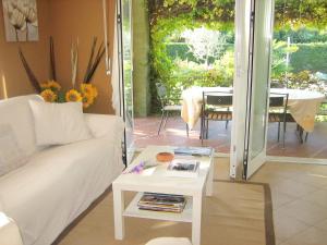 a living room with a white couch and a table at Modern Villa in Lazise with Private Pool in Lazise