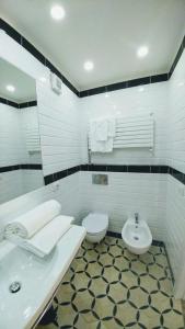 a white bathroom with a sink and a toilet at Il Colle b&b in Tivoli