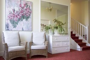 a living room with two chairs and a dresser at Résidence de Tourisme Vacances Bleues Villa Regina in Arcachon