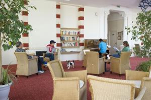 a group of people sitting in chairs in a library at Résidence de Tourisme Vacances Bleues Villa Regina in Arcachon