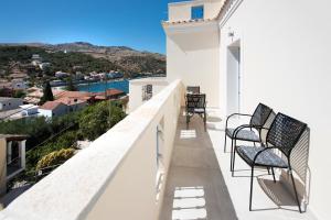 a balcony with chairs and a view of the ocean at Artheo Hotel in Kassiopi
