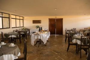 a dining room with tables and chairs in a room at Coesa Hoteis in Casa Branca
