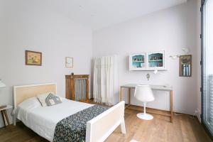 a bedroom with a bed and a desk in it at Veeve - Saint-Lambert Deluxe in Paris