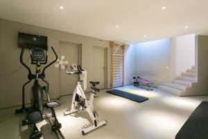 a room with a gym with exercise equipment and stairs at Veeve - Saint-Lambert Deluxe in Paris