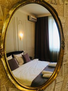 a bedroom with a bed in a mirror at Aparthotel in Chişinău