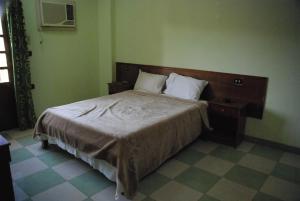 A bed or beds in a room at Dream House Apartments Luxor