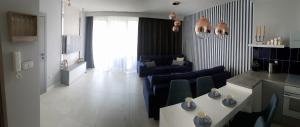 a living room with a couch and a table at Apartamenty Klifowa in Rewal