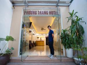 a man standing in the doorway of a proving trading house at Phuong Trang Hotel in Hanoi