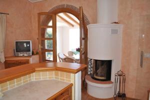 a living room with a fireplace and a tv at Villa Tiziana in Casa Morcone