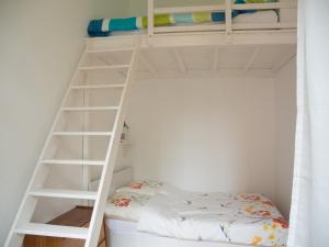 a white bunk bed with a ladder in a room at Apartment Türkis zentral in Bremen