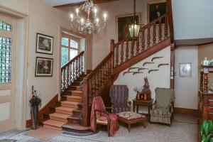 a living room with stairs and a chandelier at Domaine de la Haute-Porte in Souvigné-sur-Sarthe +26 photos