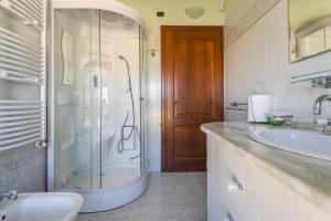 a bathroom with a shower and a sink at Anaelehouserooms LTB in Arborea  +99 photos