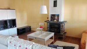 a living room with a couch and a fireplace at Camino del Morisco in Caminomorisco