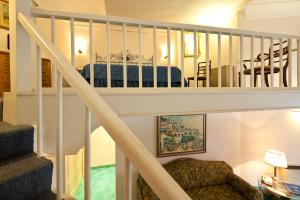 a staircase leading up to a room with a bed at Hotel Continental Ischia in Ischia