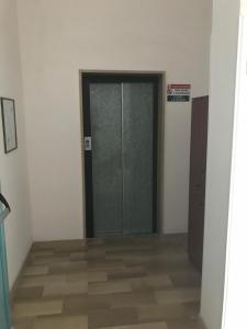 a glass door in a room with a wooden floor at Centro di Spiritualità Madonna della Nova in Ostuni