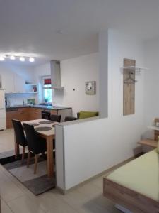 a kitchen and dining room with a table and chairs at Appartementhaus Gleirscher in Neustift im Stubaital