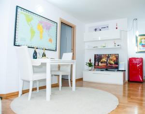 a white room with a white desk and a map on the wall at White Dream Suites in Iaşi