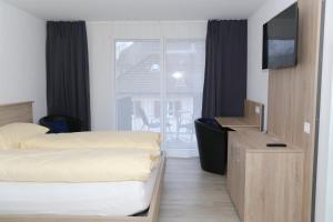 Ένα ή περισσότερα κρεβάτια σε δωμάτιο στο Hotel Traube Garni