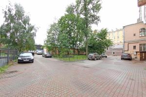 a parking lot with cars parked on a street at Sfera hotel Nevsky 163 in Saint Petersburg