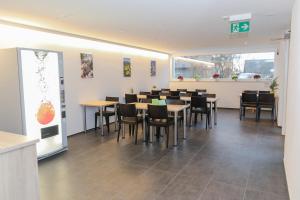 a dining room with tables and chairs in a restaurant at Hotel Traube Garni in Küttigen