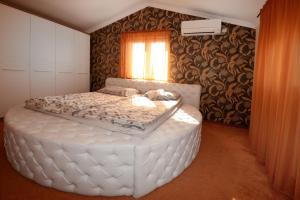 a large white bed in a room with a window at Villa Zare in Poreč +78 photos