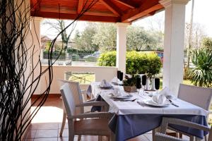 a table with a blue table cloth on a patio at Villa Zare in Poreč