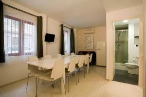 a dining room with a table and chairs and a bathroom at Old City Beach House in Barcelona