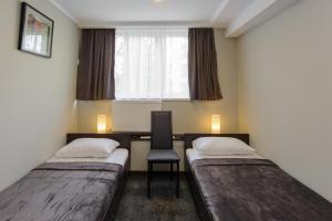 Un pat sau paturi într-o cameră la Hotel Reverence