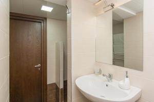 a bathroom with a sink and a mirror at Hotel Reverence in Tbilisi City