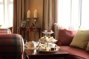 a table with three plates of food on a table at Kinloch Lodge Hotel and Restaurant in Kinloch