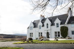 a white house with a black roof at Kinloch Lodge Hotel and Restaurant in Kinloch