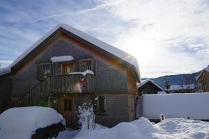 a house with snow on the front of it at Ferienwohnung Wüstner in Schwarzenberg