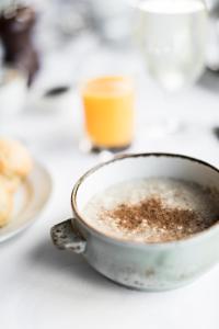 a bowl of coffee sitting on a table at Kinloch Lodge Hotel and Restaurant in Kinloch