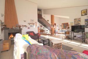 a living room with a couch and a fireplace at Magma Guest House in Ragalna