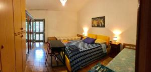 a room with a bed and a table in it at Casa Ai Piedi Della Riserva Naturale in Pettorano sul Gizio