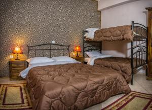 a bedroom with two bunk beds and two lamps at Xenonas Sta Tzakia in Karpenisi +37 photos