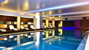 a hotel room with a swimming pool and a hotel at Pestana Buenos Aires in Buenos Aires