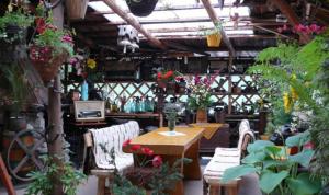 a patio with a table and chairs and flowers at Wynajem Pokoi Krystyna Mróz in Zakopane