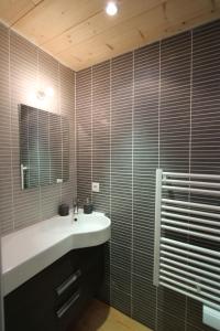 a bathroom with a sink and a mirror at Chalet Barcelonnette in Barcelonnette