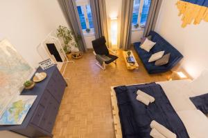 an overhead view of a living room with a blue couch at Stunning Apartment Vienna Central Station in Vienna